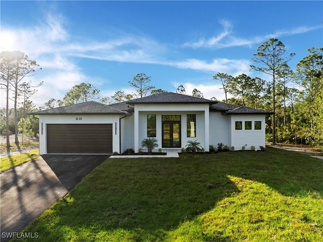 view of front of house featuring a front lawn and a garage