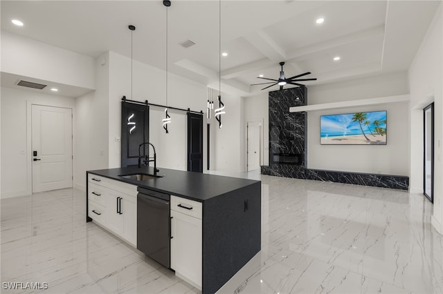 kitchen with sink, a barn door, black dishwasher, decorative light fixtures, and white cabinetry