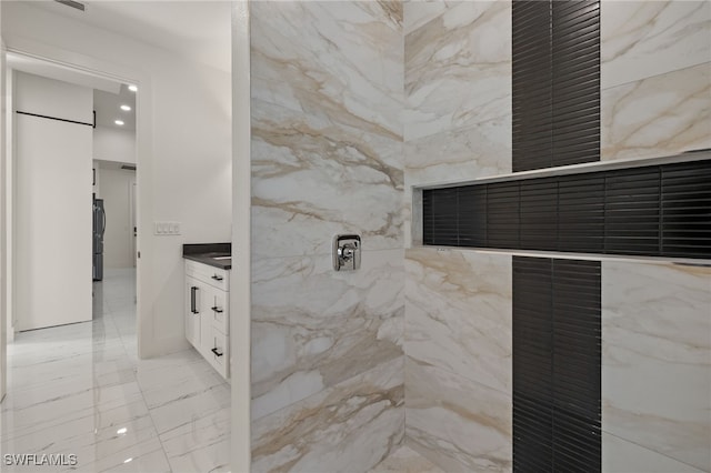 bathroom with a shower and vanity