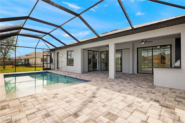 view of pool with a patio area, ceiling fan, and a lanai