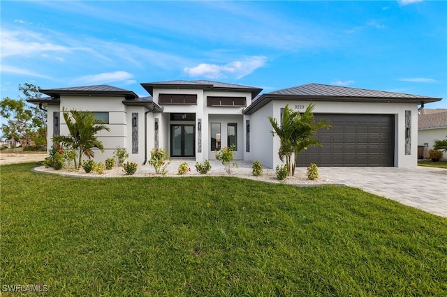 prairie-style home with a garage and a front lawn