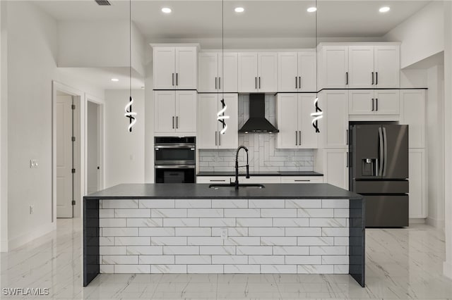 kitchen with white cabinets, decorative backsplash, wall chimney exhaust hood, and stainless steel appliances