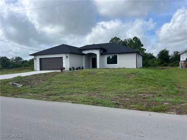 view of front facade with a garage and a front yard