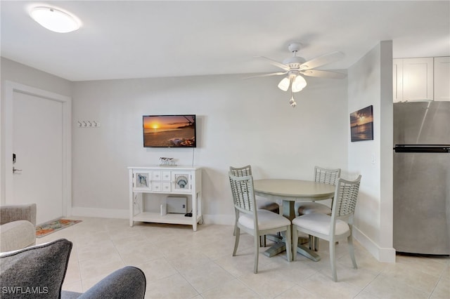 tiled dining area with ceiling fan