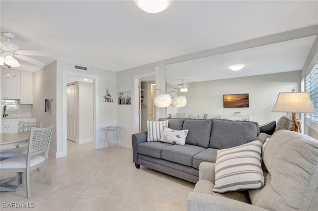 tiled living room with ceiling fan