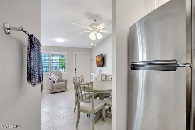 dining area with light tile patterned floors and ceiling fan