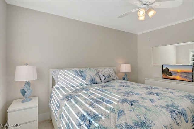 tiled bedroom with ceiling fan and crown molding