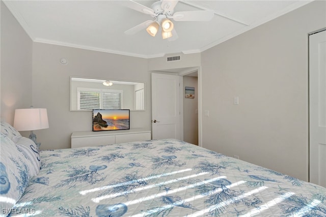 bedroom with ceiling fan and crown molding