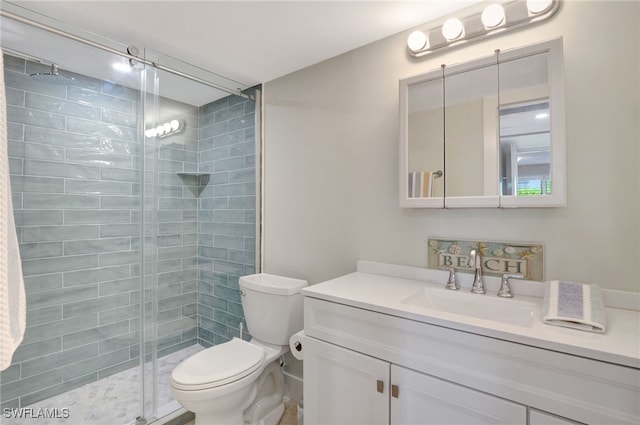 bathroom featuring vanity, toilet, and walk in shower