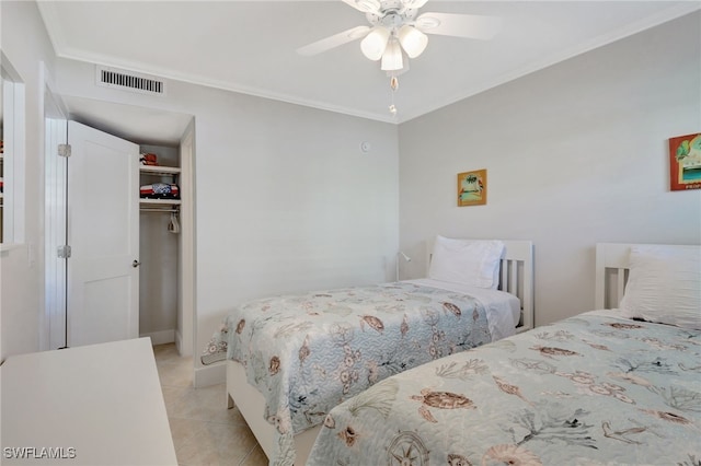 bedroom featuring a closet, ceiling fan, ornamental molding, and light tile patterned flooring