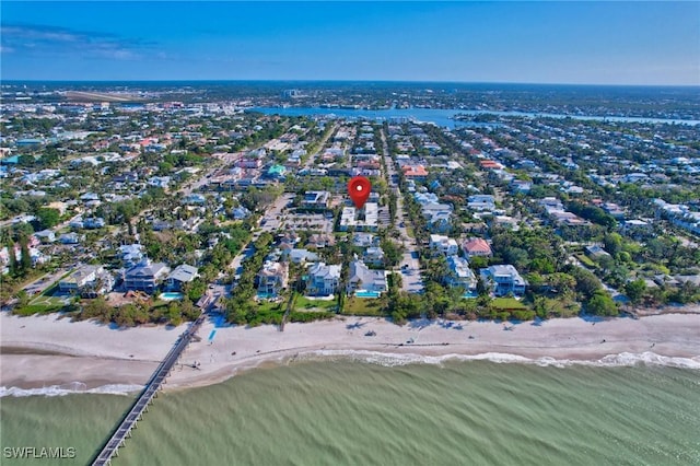 bird's eye view with a water view and a beach view