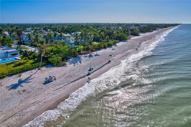 drone / aerial view featuring a beach view and a water view