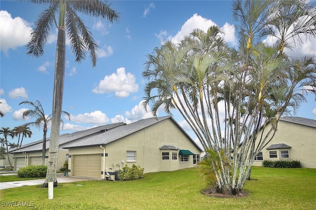 view of home's exterior featuring a garage and a yard