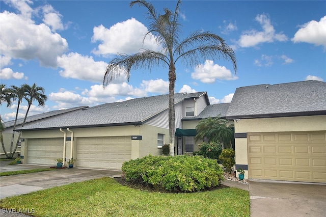 view of front facade featuring a garage and a front lawn