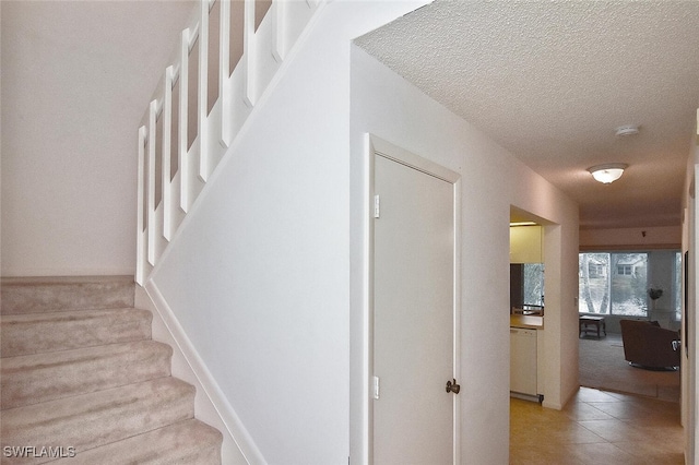 102 Mcgregor Park Cir Unit 102, Fort Myers, FL 33908 - staircase featuring a textured ceiling, carpet, and tile patterned floors