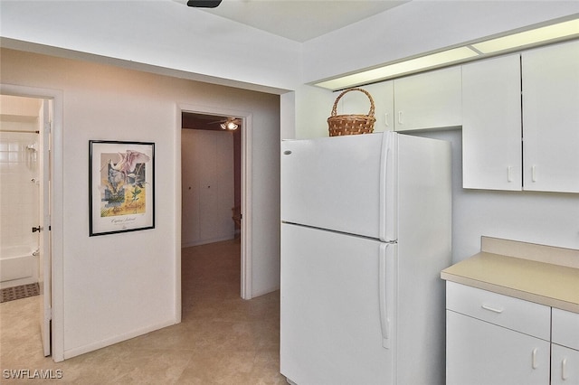 kitchen with white cabinetry and white refrigerator