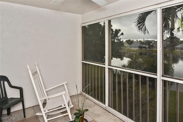 sunroom / solarium featuring a water view