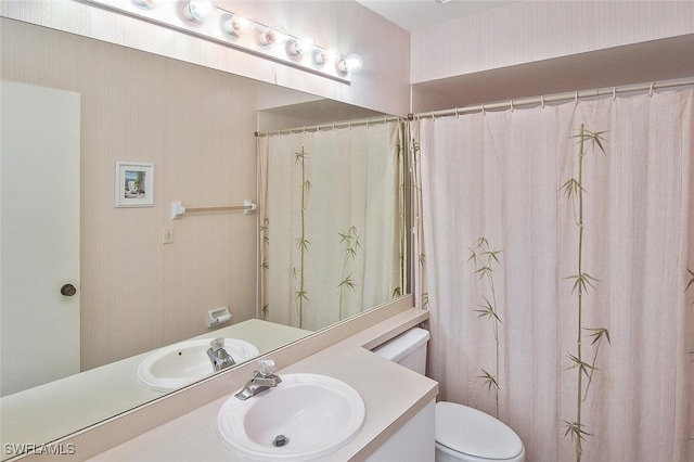 bathroom featuring vanity and toilet