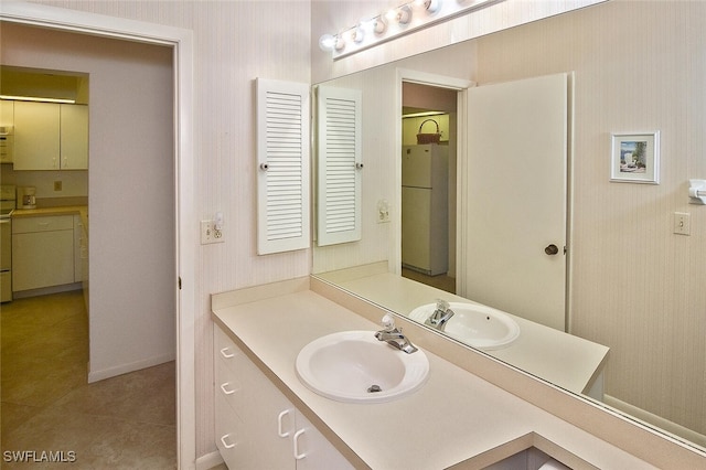 102 Mcgregor Park Cir Unit 102, Fort Myers, FL 33908 - bathroom with wallpapered walls, vanity, and tile patterned flooring