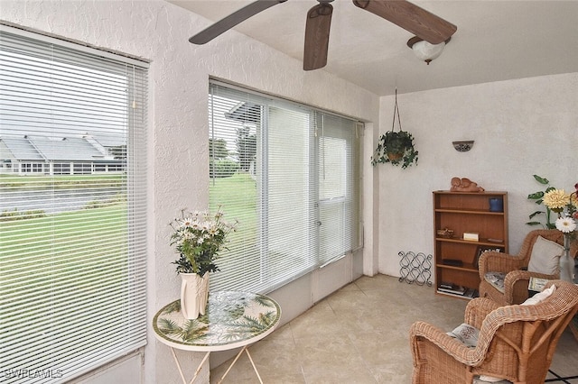 sunroom / solarium featuring ceiling fan