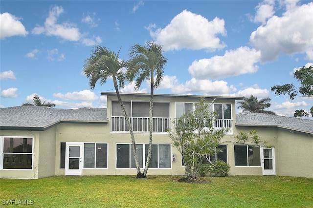 rear view of property with a lawn