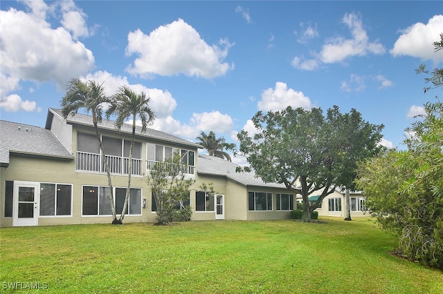 rear view of property with a lawn