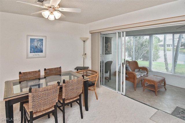 dining room with a textured ceiling and ceiling fan