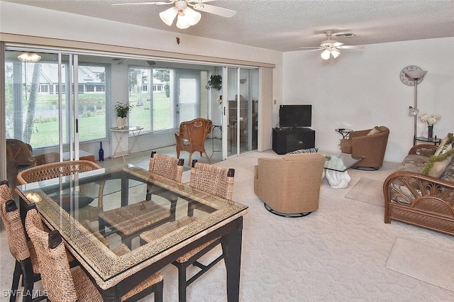 carpeted living room with a textured ceiling and ceiling fan