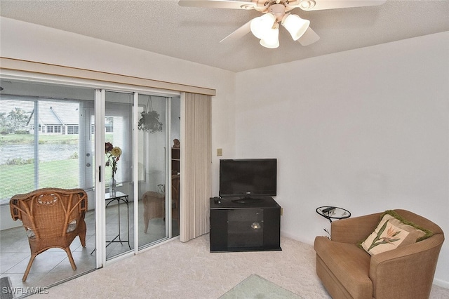 living area featuring a textured ceiling and ceiling fan