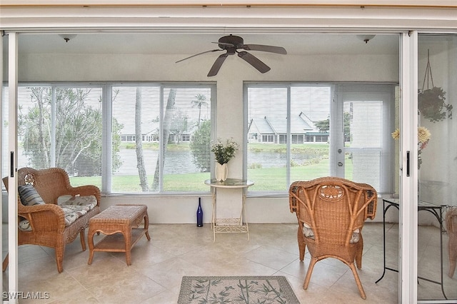 sunroom / solarium featuring ceiling fan