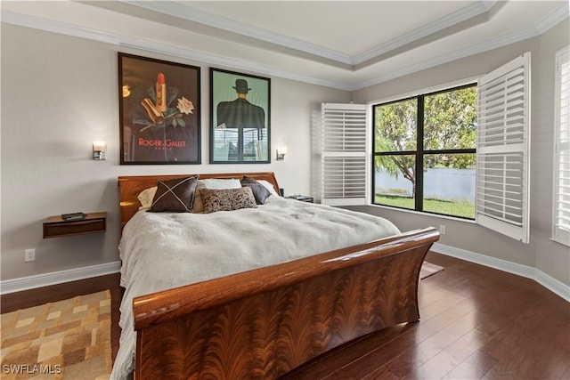 bedroom featuring a raised ceiling, dark hardwood / wood-style flooring, and ornamental molding