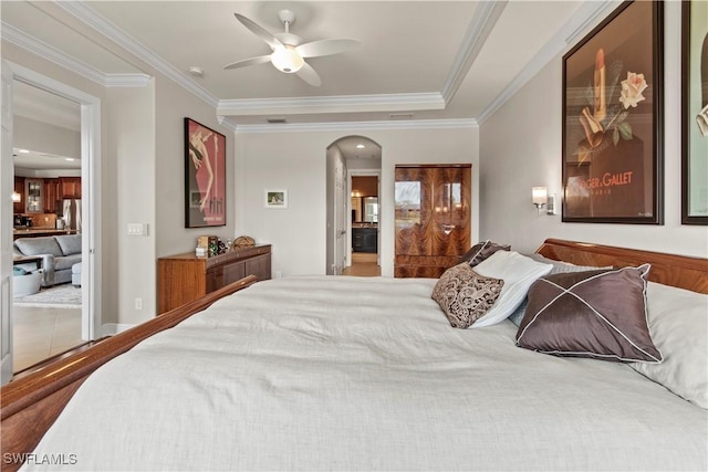 bedroom featuring ceiling fan, crown molding, and stainless steel refrigerator