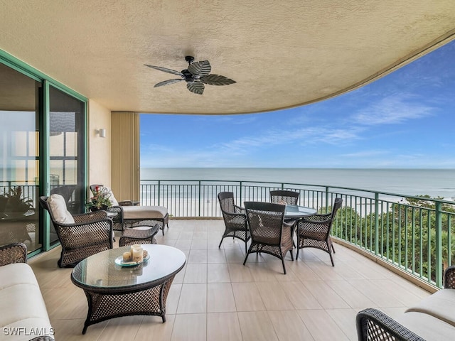 view of patio / terrace with an outdoor hangout area, a balcony, ceiling fan, and a water view