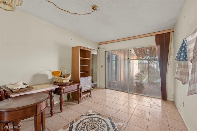 living area featuring light tile patterned flooring and a textured ceiling