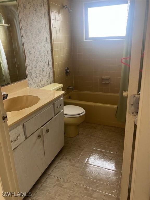 full bathroom with tile patterned flooring, shower / bath combo, vanity, and toilet