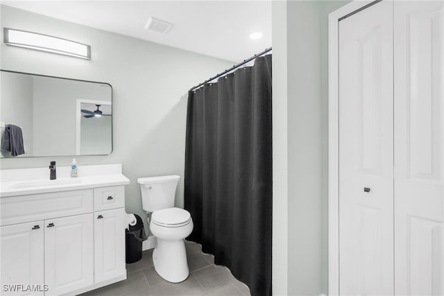 bathroom with tile patterned floors, vanity, and toilet