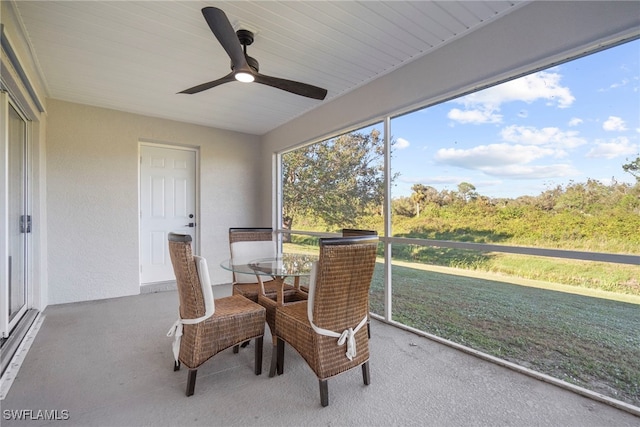 sunroom featuring ceiling fan