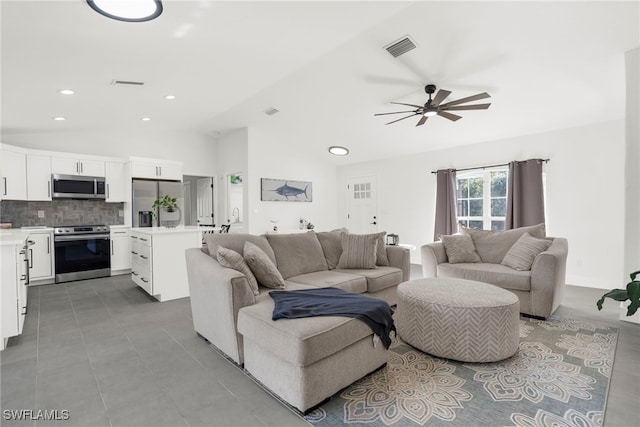 living room featuring ceiling fan and vaulted ceiling