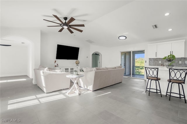 living room with vaulted ceiling, ceiling fan, and light tile patterned flooring