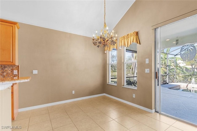 unfurnished dining area featuring light tile patterned floors, a chandelier, and lofted ceiling