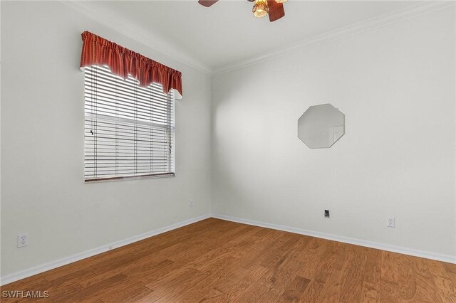 empty room featuring wood-type flooring, ceiling fan, and crown molding