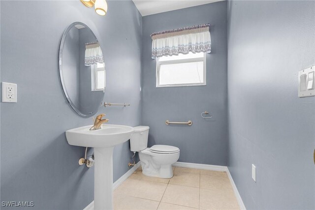 bathroom featuring tile patterned flooring and toilet