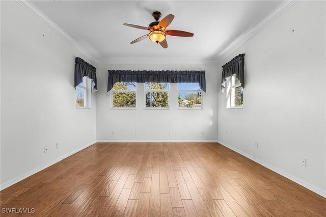 spare room with hardwood / wood-style floors, ceiling fan, and crown molding