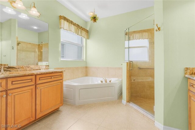 bathroom with tile patterned flooring, vanity, and plus walk in shower