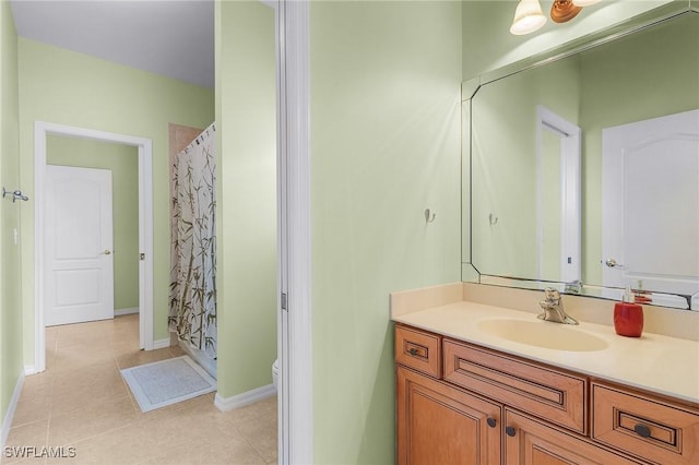 bathroom featuring tile patterned floors, vanity, toilet, and walk in shower