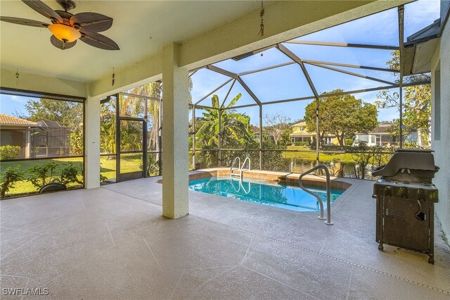 view of swimming pool with glass enclosure, a grill, a patio area, and ceiling fan