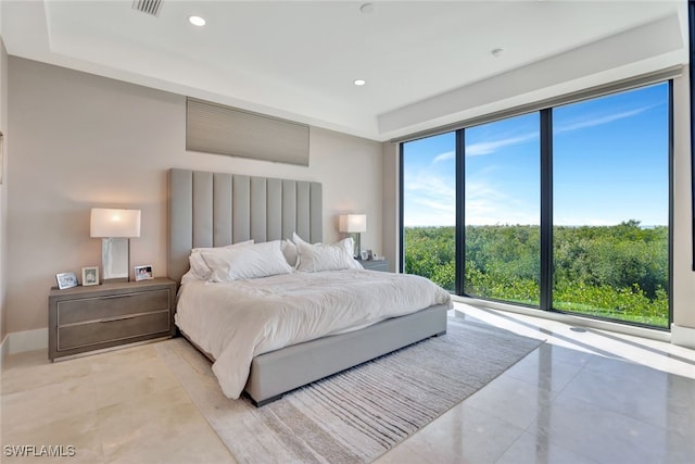 bedroom featuring expansive windows and multiple windows