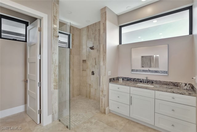 bathroom with vanity and tiled shower