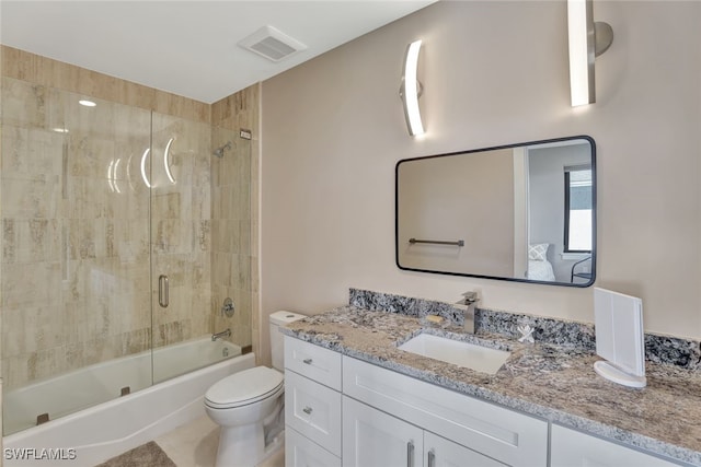 full bathroom with vanity, toilet, and enclosed tub / shower combo