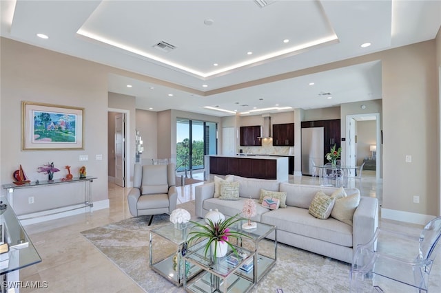 living room featuring a tray ceiling